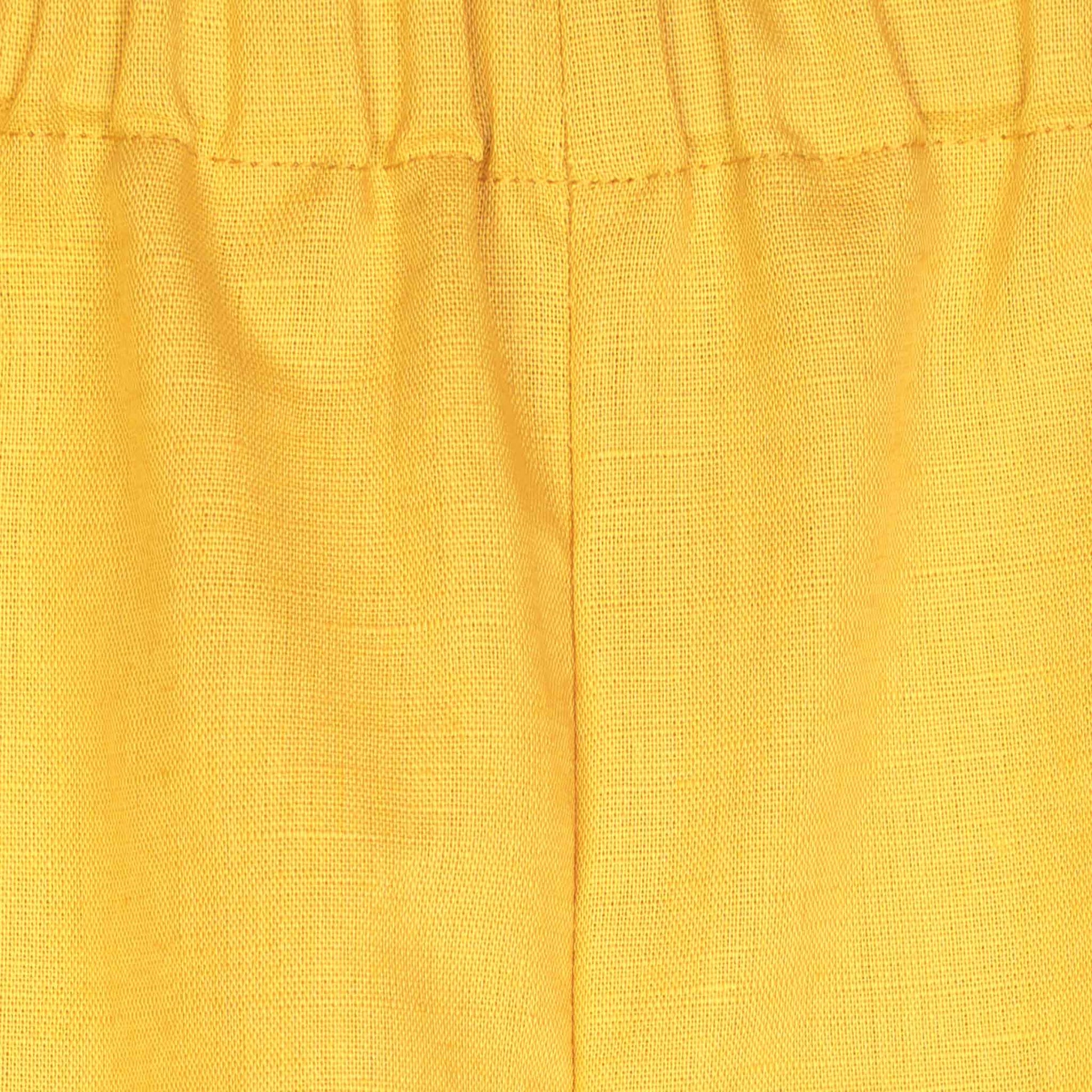 Pantapalazzo lungo giallo da bambina con elastico in vita e gamba ampia vista particolare cucitura